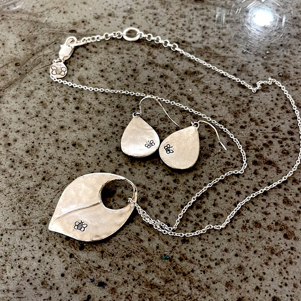 Silver necklace with matching earrings.